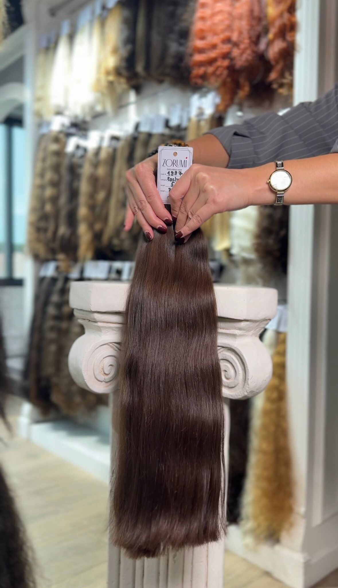 Dark straight donor hair ponytail with dense, blunt ends