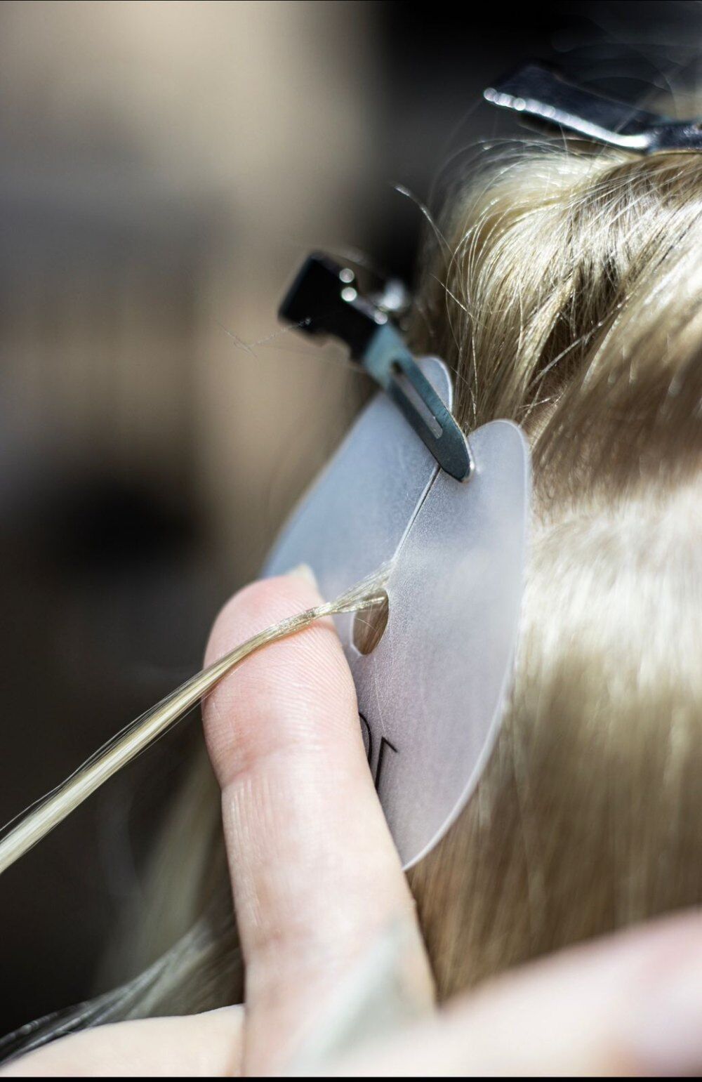 Close-up of a ZORUMI Italian hot keratin extension application